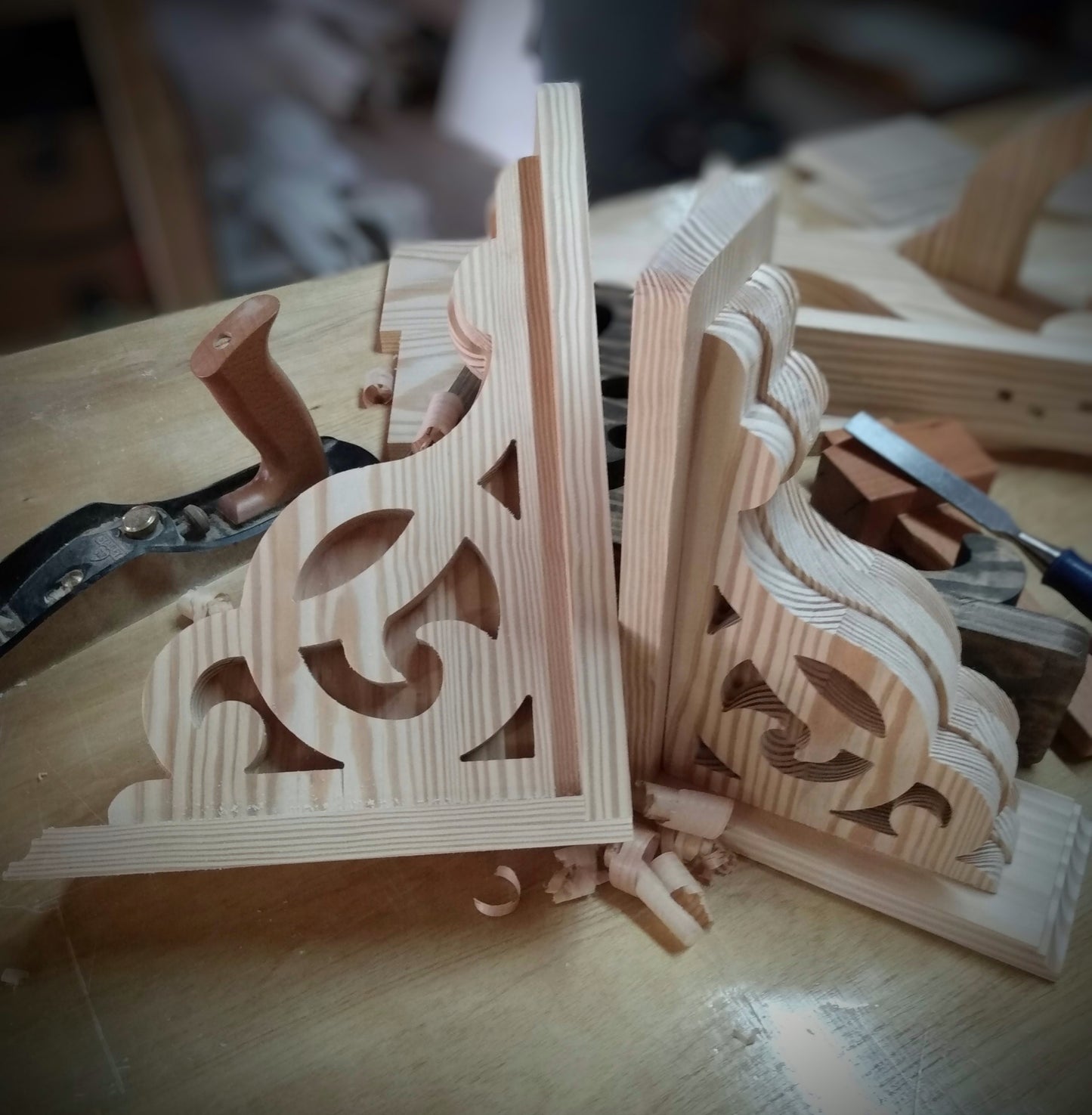 Pair of wooden corbels on work bench
